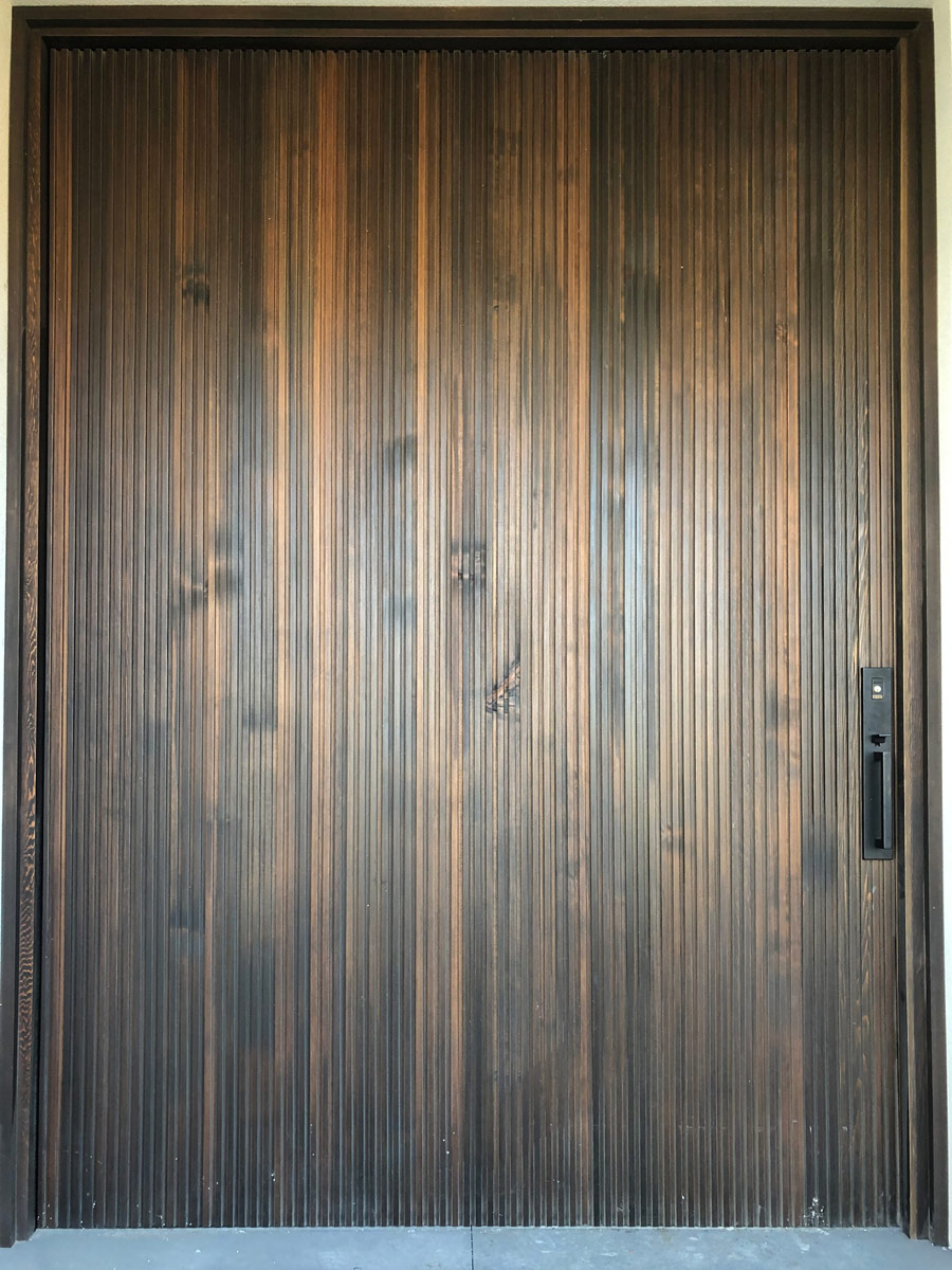 Timber entry door: A sturdy wooden door with a natural finish, providing an elegant and durable entrance to a building