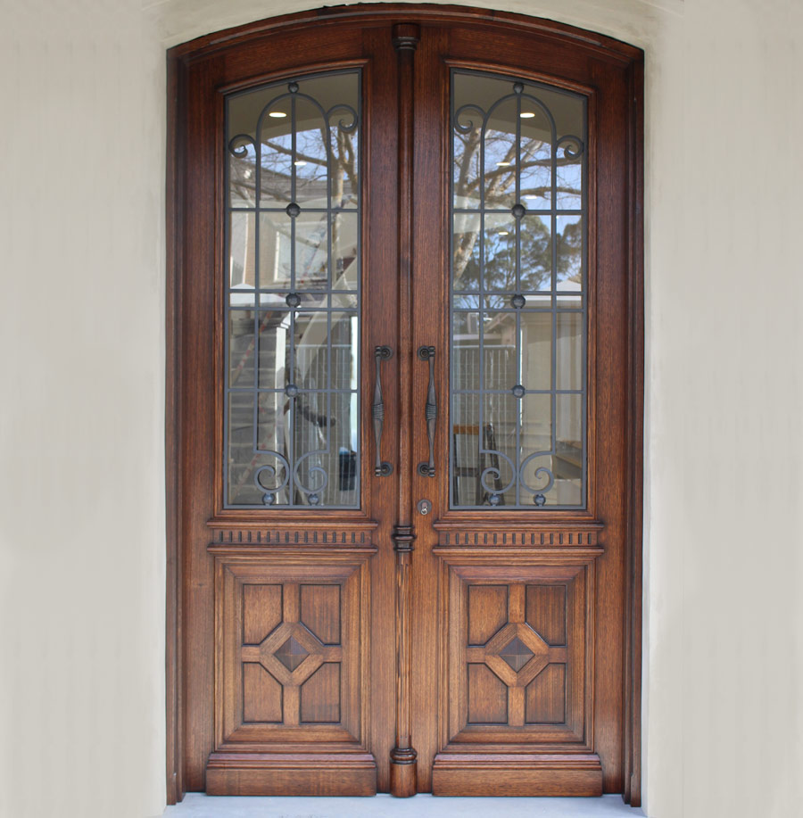 Front entrance doors with elegant glass panels and intricate metalwork design